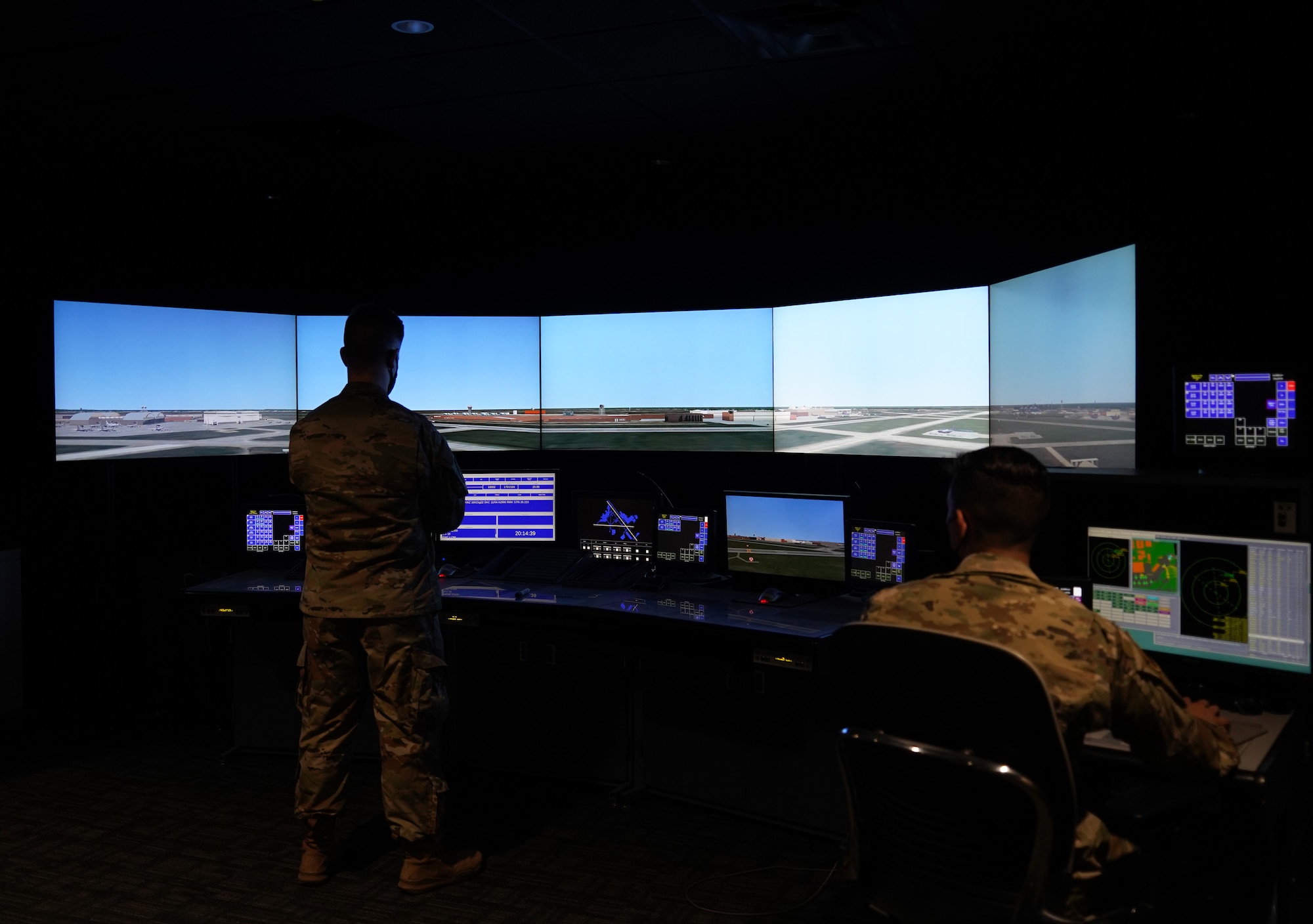 Two airmen in a simulated environment