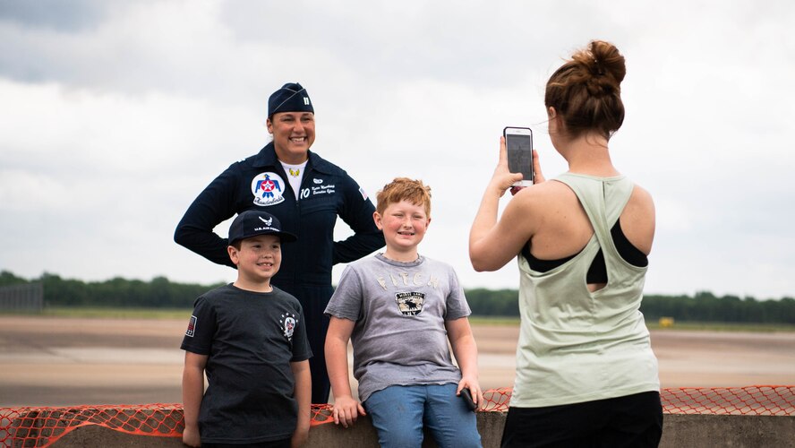 Capt. Katie Moorkamp, United States Air Force Air Demonstration Squadron, “Thunderbirds," executive officer, poses for a photo with kids visiting the 2021 Defenders of Liberty Air & Space Show at Barksdale Air Force Base, Louisiana, May 9, 2021. Barksdale's Air Show showcased performances from the Thunderbirds, F-22 Raptor Demonstration Team and a host of additional acts. (U.S. Air Force photo by Senior Airman Jacob B. Wrightsman)
