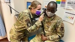 Air Force 1st Lt. Katelyn Schoneweis, a clinical nurse at Eielson Medical Clinic at Eielson Air Force Base, Alaska, checks on Air Force Staff Sgt. Ibrahim Kumenda.
