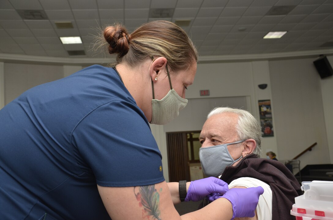 Nurse gives a vaccine shot