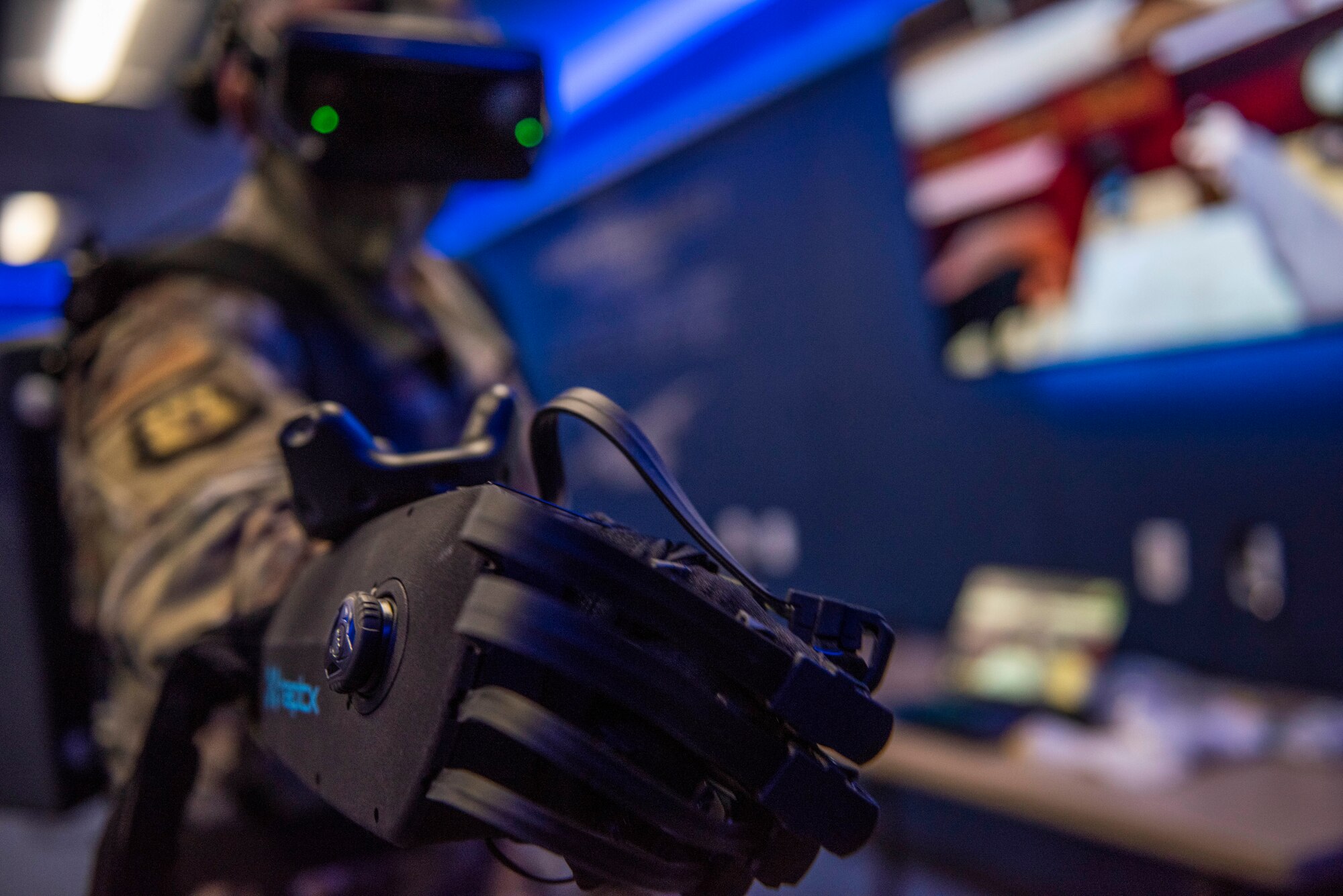 Chief Master Sgt. Mark Umfleet, 317th Airlift Wing command chief, tests HaptX Gloves Development Kit 2 at Dyess Air Force Base, Texas, May 10, 2021. The DK2 Gloves have 113 pressure points in each glove that provides a realistic response to enhance the physical aspect of each training experience. (U.S. Air Force photo by Airman 1st Class Colin Hollowell)