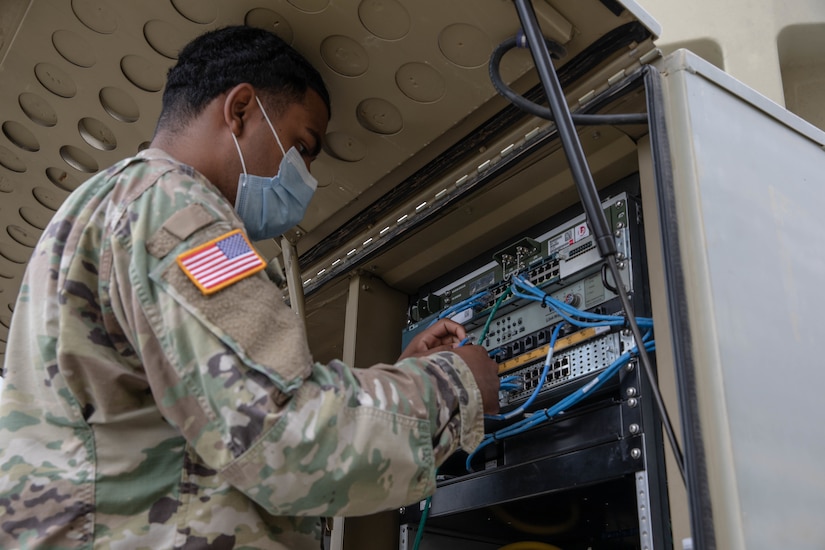 A soldier works on a network.