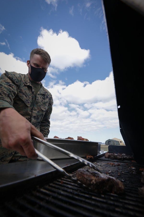 U.S. Marine Corps Cpl. Charles Squires III, a food service specialist with Combat Logistics Regiment 45, 4th Marine Logistics Group, prepares dinner for Marines during Arctic Care 2021 in Kodiak, Alaska, on May 6, 2021. Arctic Care 2021 is a joint-service training mission led by the United States Air Force and supported by members of the Air National Guard, Marines, Marine Reserves, Navy, Navy Reserves, National Guard, and Army Reserves. (U.S. Marine Corps photo by Lance Cpl. James Stanfield)