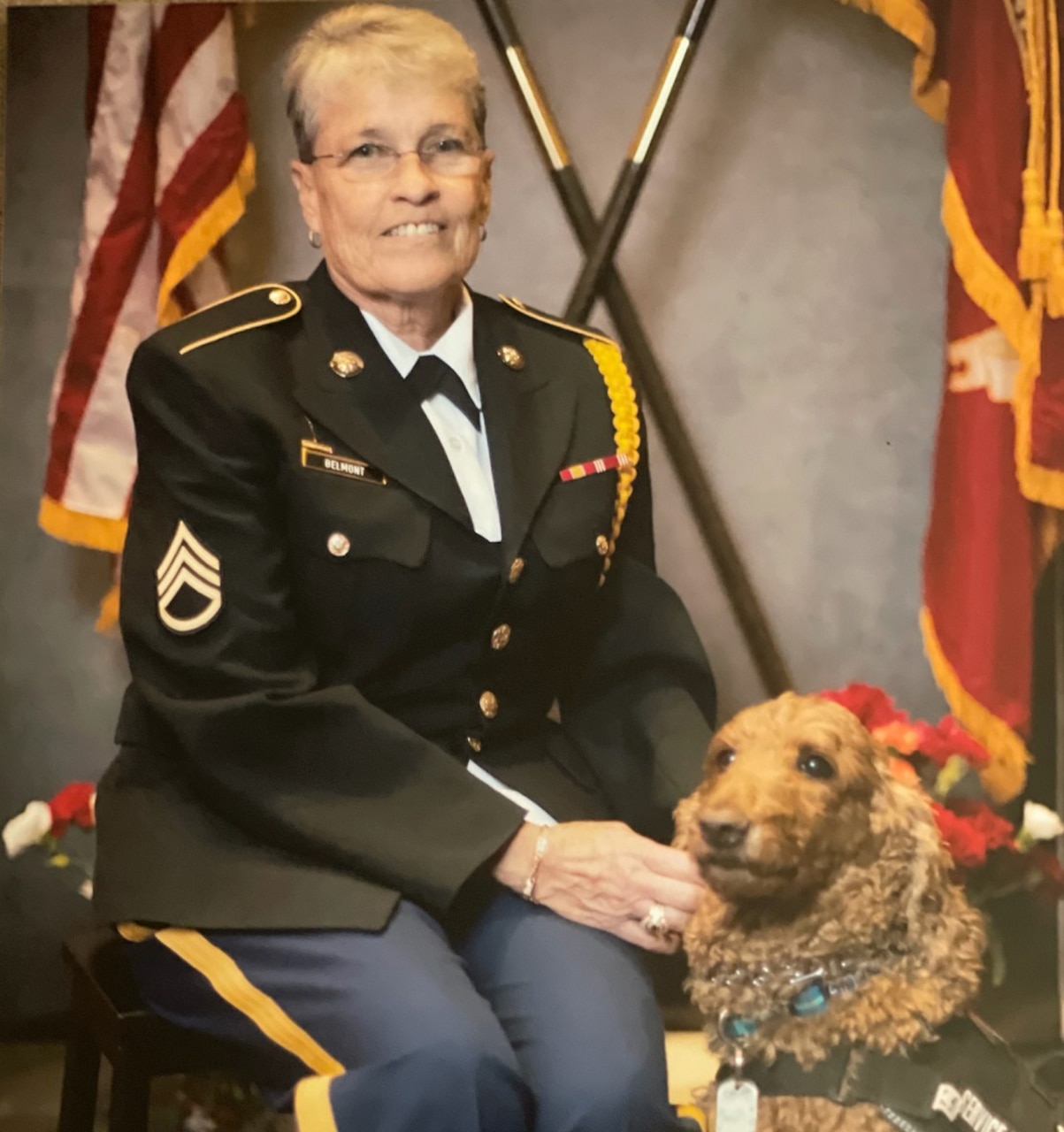 A woman in a military uniform poses for a photo.