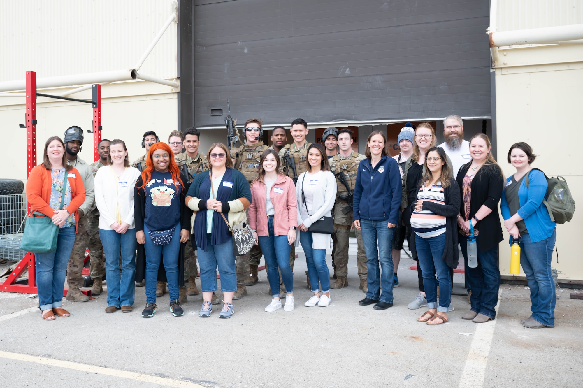 Airmen from the 341st Missile Security Operations Squadron tactical response force and military spouses pose for a photo during a tour May 7, 2021, at Malmstrom Air Force Base, Mont.