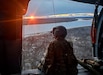 Sgt. Rosalind Stromberg, a crew chief from 1st Battalion, 207th Aviation Regiment, Alaska Army National Guard, looks over the Kuskokwim River from the door of a UH-60L Black Hawk helicopter during a rescue mission, May 10. The helicopter aircrew rescued four individuals and their dog from their boat on the river after they became stuck between Bethel and Kwethluk because of ice from break up blocking their egress. All four individuals and their dog were hoisted into the helicopter and transported back to Bethel safely. For this mission, the 207th AVN was awarded with four saves. (Courtesy photo by Spc. Kia Hasson)