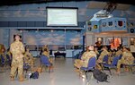 A group of 960th Cyberspace Wing Reserve Citizen Airmen receive a briefing on officer promotion boards April 28, 2021, at the Museum of Aviation, Robins Air Force Base, Georgia, during the 960th CW 2021 Leadership Summit. (U.S. Air Force photo by Tech. Sgt. Samantha Mathison)