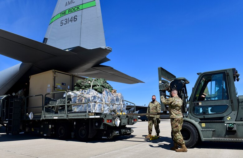 Airmen offload cargo from a C-130J Super Hercules