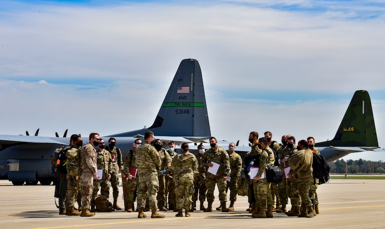 Airmen assigned to the 19th Airlift Wing are briefed after arriving at Volk Field Air National Guard Base