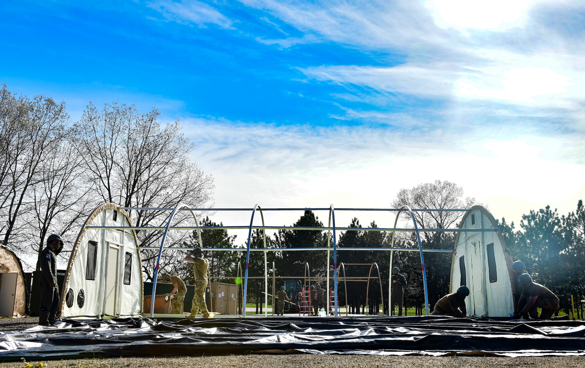 Airmen set up a military shelter system