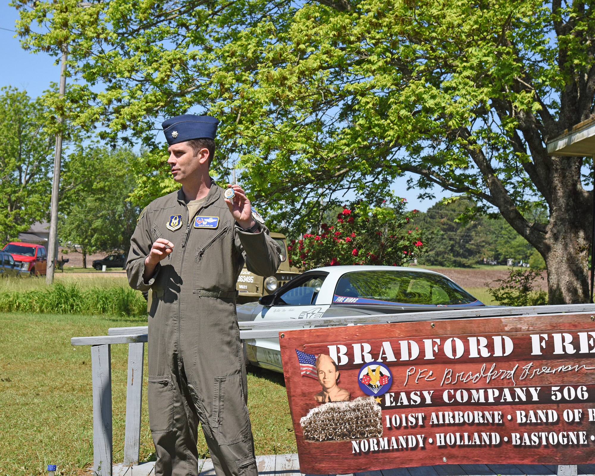 Lt. Col. Jason Barlow holds a coin that is to be presented to Bradford Freeman.