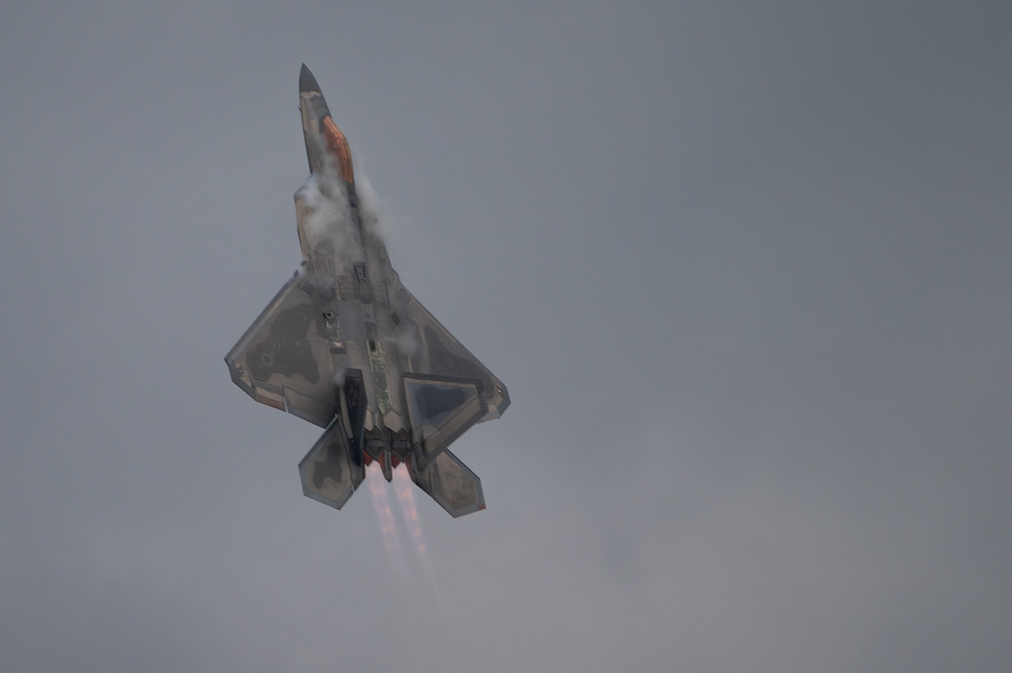 A U.S. Air Force F-22A Raptor flies through clouds during the 2021 Defenders of Liberty Air & Space Show at Barksdale Air Force Base, Louisiana, May 9, 2021. The F-22A, a fifth-generation fighter incorporating fourth-generation stealth aircraft, has the ability to fly at supersonic speed without afterburners. (U.S. Air Force photo by Airman 1st Class Jon)