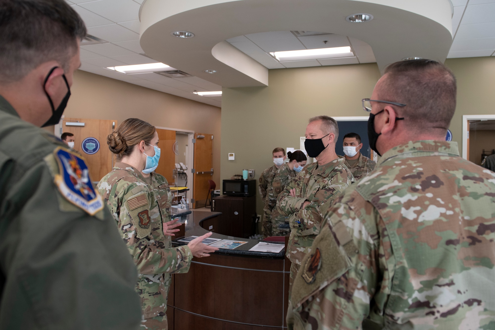 A photo of Airmen standing in a room during a briefing.