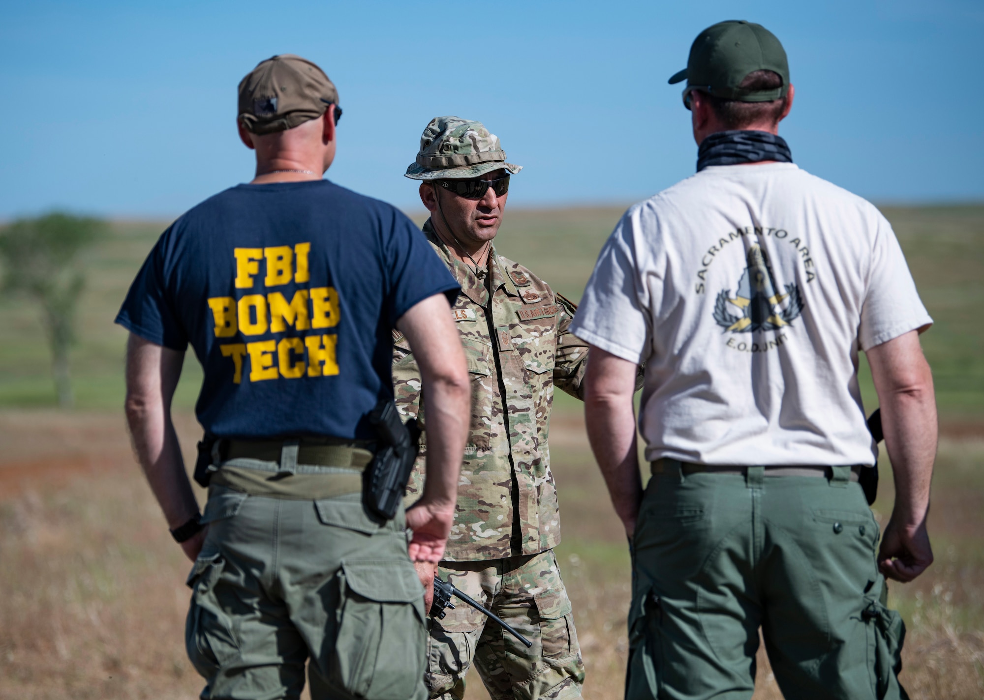 Master Sgt. Jayson Wells, 9th Civil Engineer Squadron Explosive Ordnance Disposal (EOD) superintendent, center, talks with members of the FBI and Sacramento Sheriff’s office.