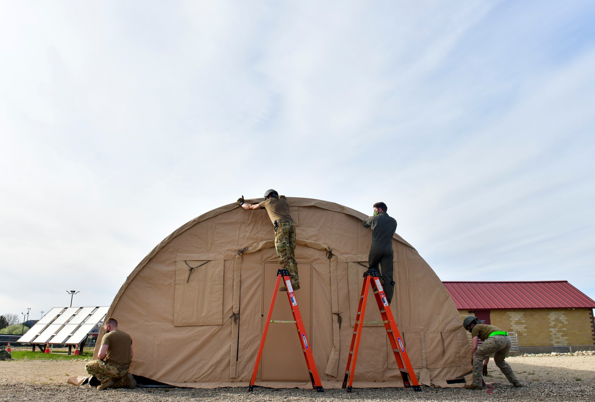Airmen assigned to the 19th Airlift Wing assemble a military shelter system