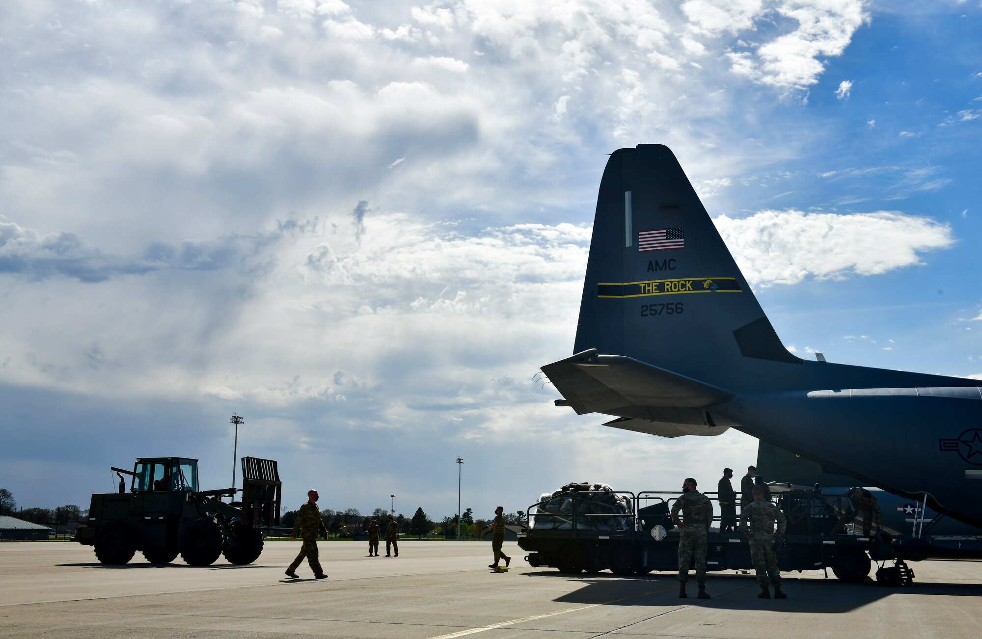 Airmen assigned to the 19th Airlift Wing offload cargo from a C-130J Super Hercules at