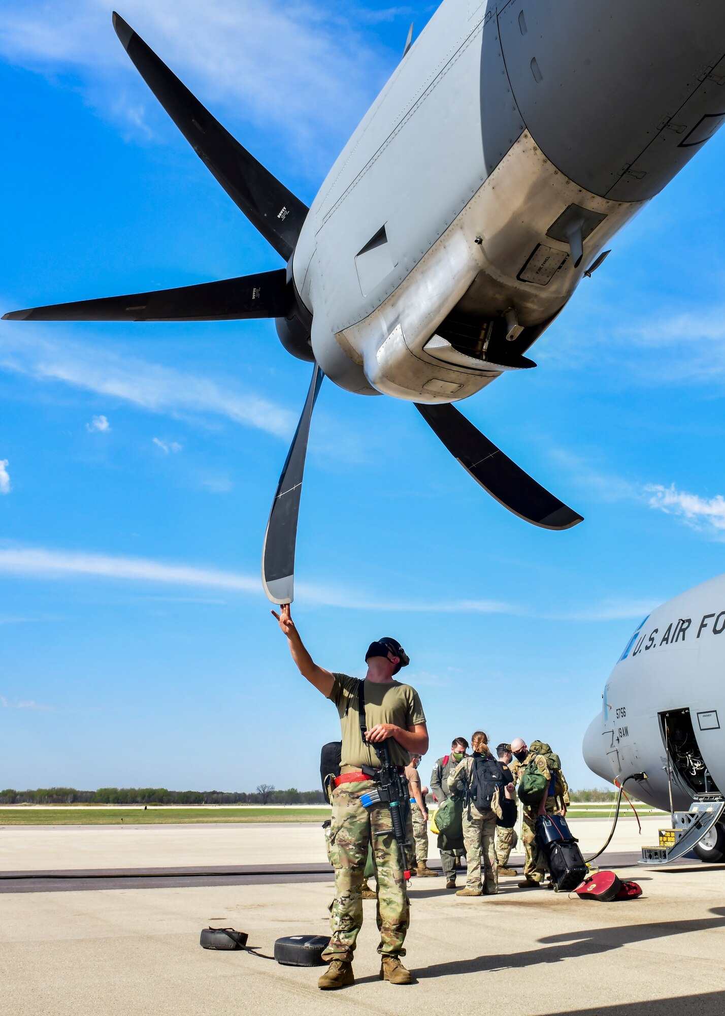 An Airman assigned to the 19th Airlift Wing examines a C-130J Super Hercules engine propeller
