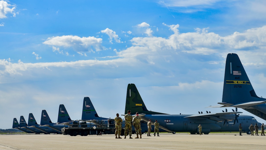 Eight C-130J Super Hercules are parked on the flightline
