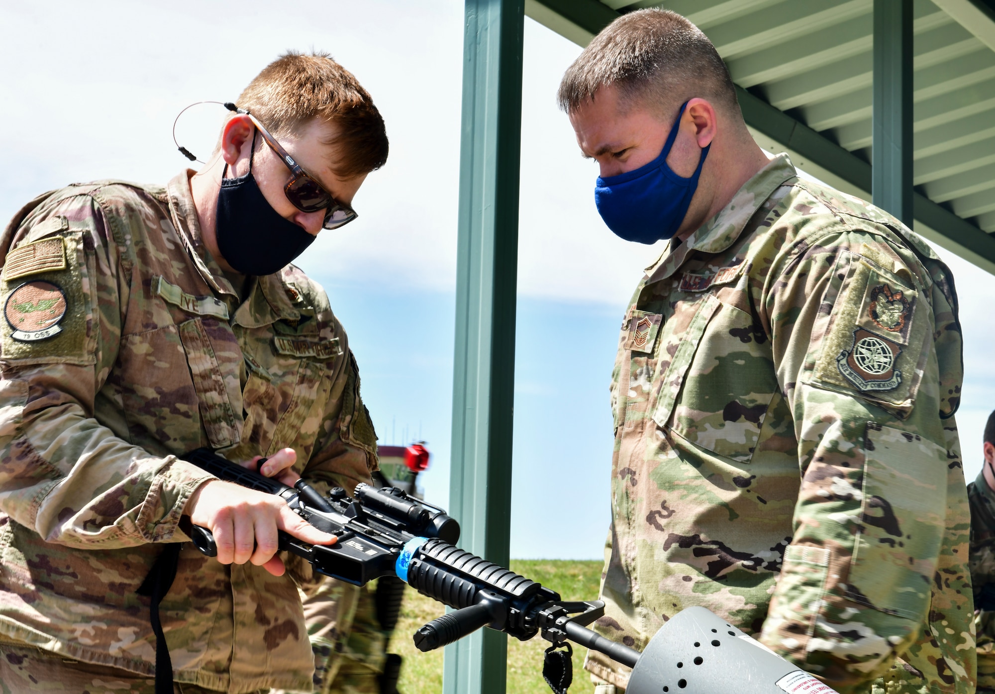 An Airman assigned to the 19th Airlift Wing clears his M-4 rifle
