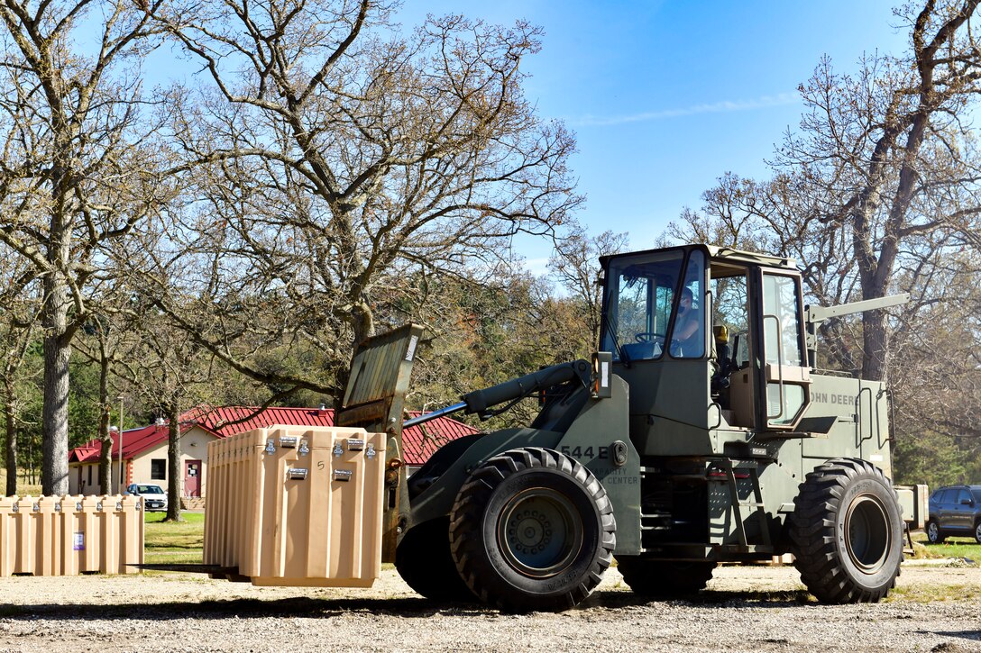 An Airman moves a military shelter system