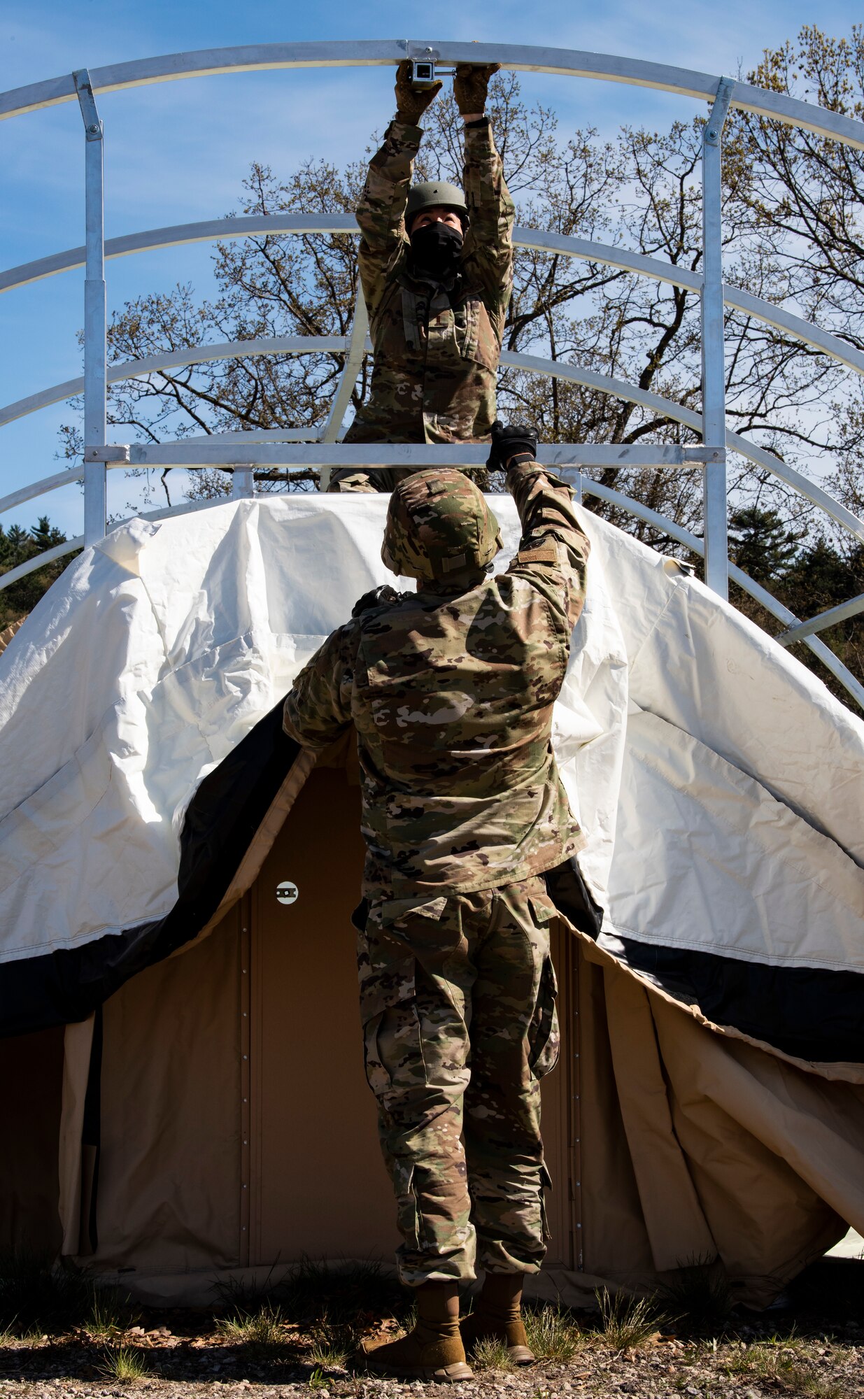 Airmen assemble a military shelter system