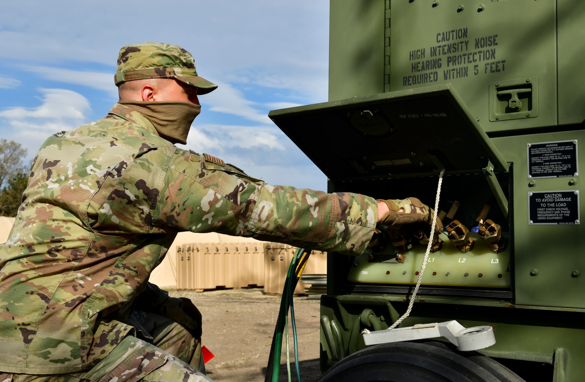 An Airman hooks up a generator