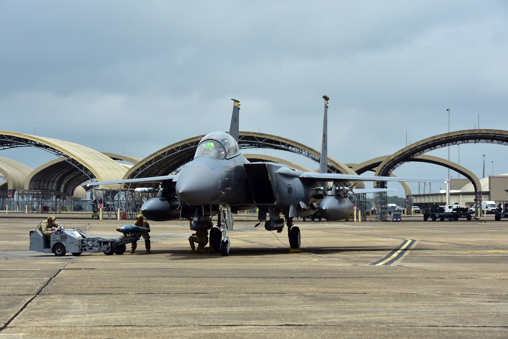 An inert munition is loaded onto a F-15E Strike Eagle