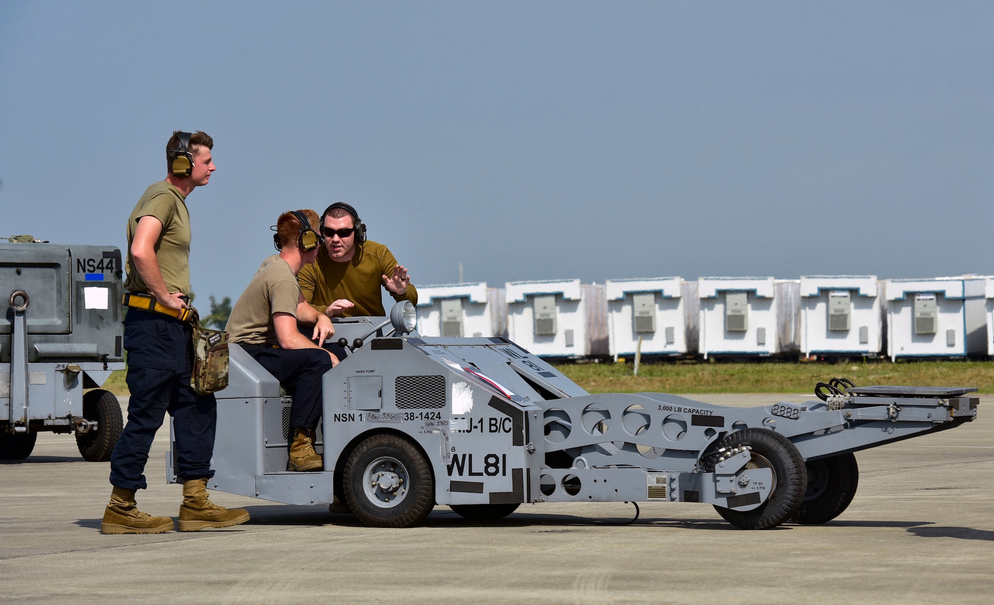 A weapons load crew load operate a MJ-1 Bomb Lifter “Jammers”