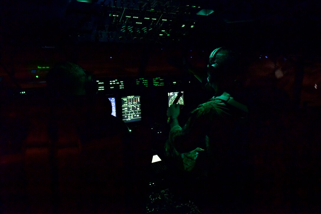An Airman conducts pre-flight checks on a C-130J Super Hercules