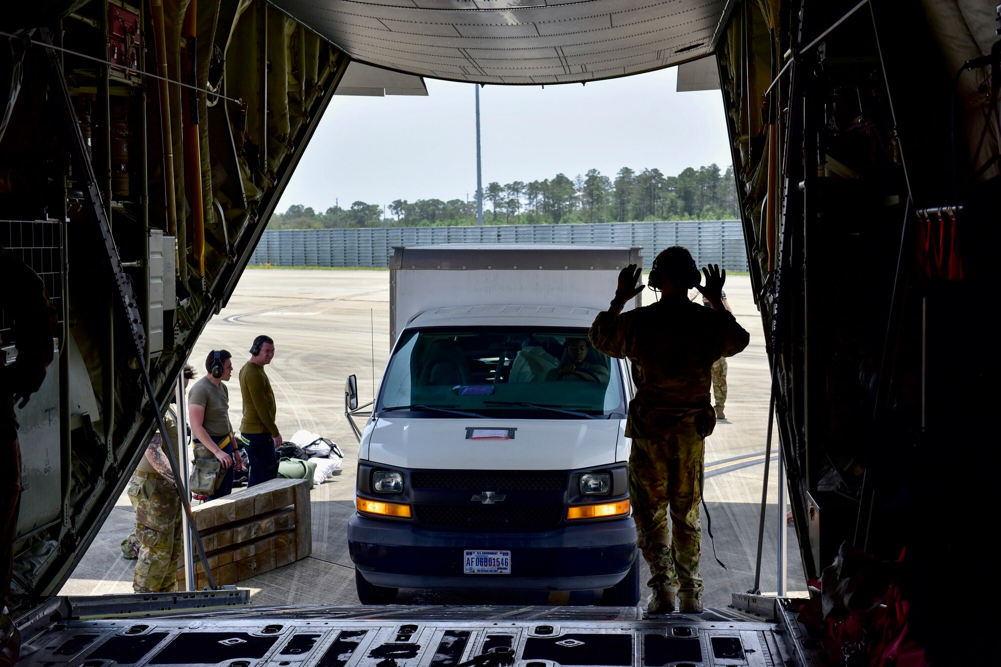 An Airman offloads a vehicle from a C-130J Super Hercules