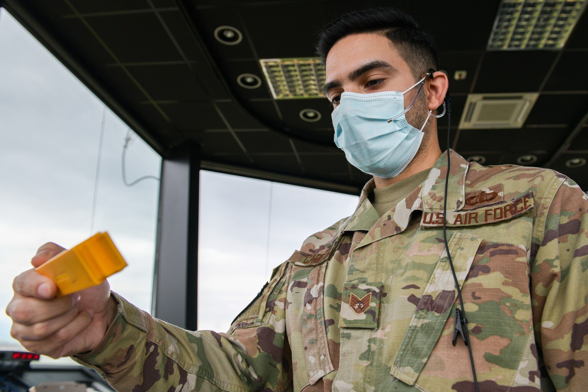 U.S. Air Force Staff Sgt. Daniel Cabezas, 31st Operations Support Squadron, air traffic controller, looks over a flight plan in the Air Traffic Control Tower at Aviano Air Base, Italy, May 7, 2021. Flight strips are used to verify an aircraft’s flight plan along with recordings of the controller’s audio communication with the aircraft. ATCs separate traffic by staying in communication with the pilots as they land and takeoff. (U.S. Air Force photo by Airman 1st Class Brooke Moeder)