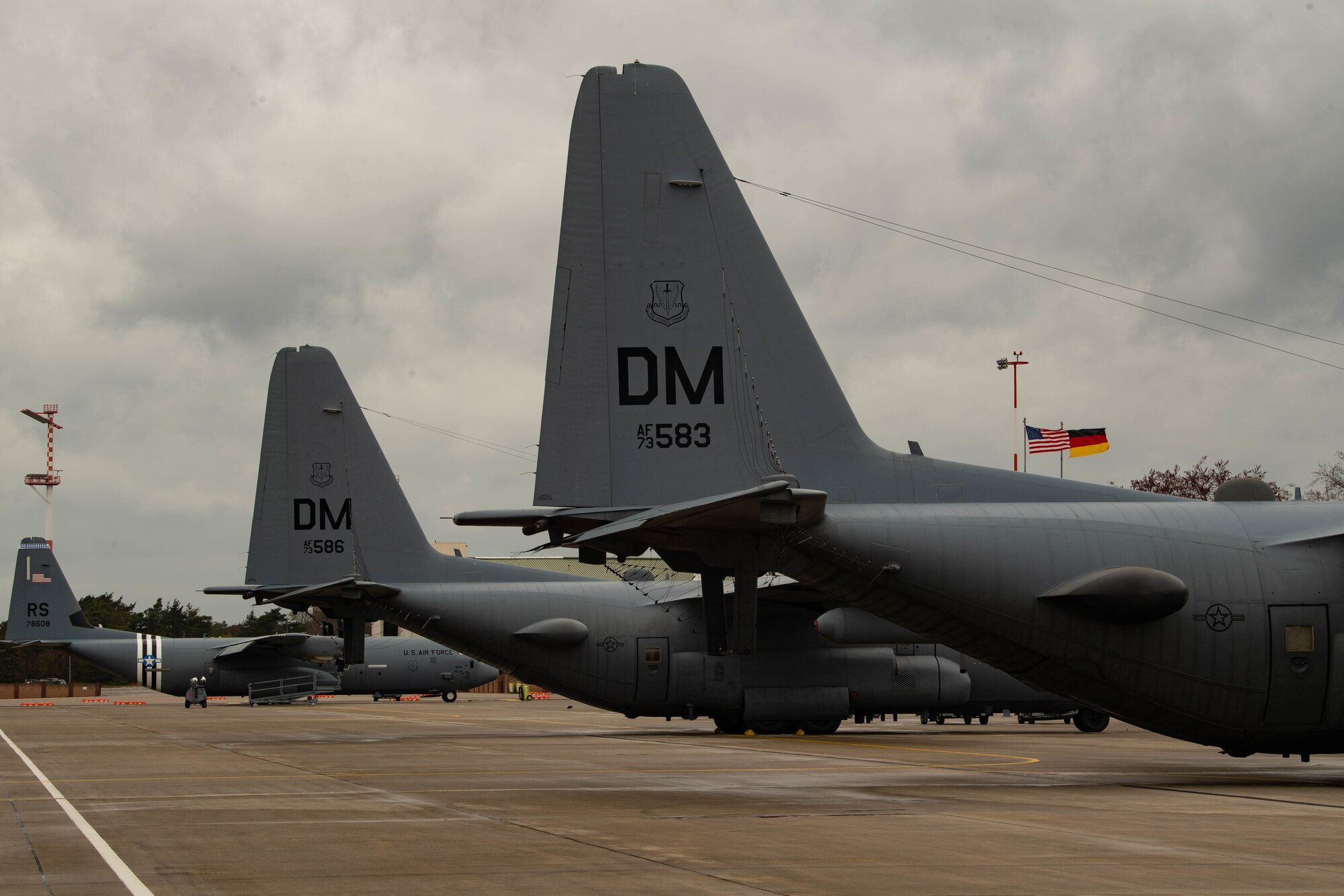 Three aircraft parked on flight line