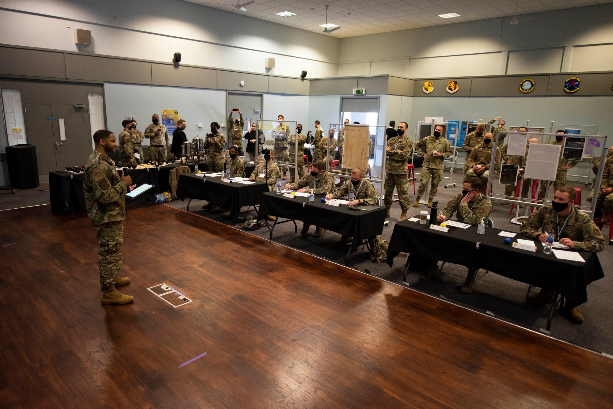 U.S. Air. Force Staff Sgt. Thaddeus Johnson, left, 423rd Force Support Squadron noncommissioned officer in charge of Date Estimated Return from Overseas DEROS and retentions, presents his team’s innovation project during Pathfinder Shark Tank at the Pathfinder Innovation Conference 2021 at Royal Air Force Croughton, England, May 6, 2021. The 501st Combat Support Wing hosted its first innovation conference to highlight new ideas and promote a culture of innovation within the wing. (U.S. Air Force photo by Senior Airman Jennifer Zima)