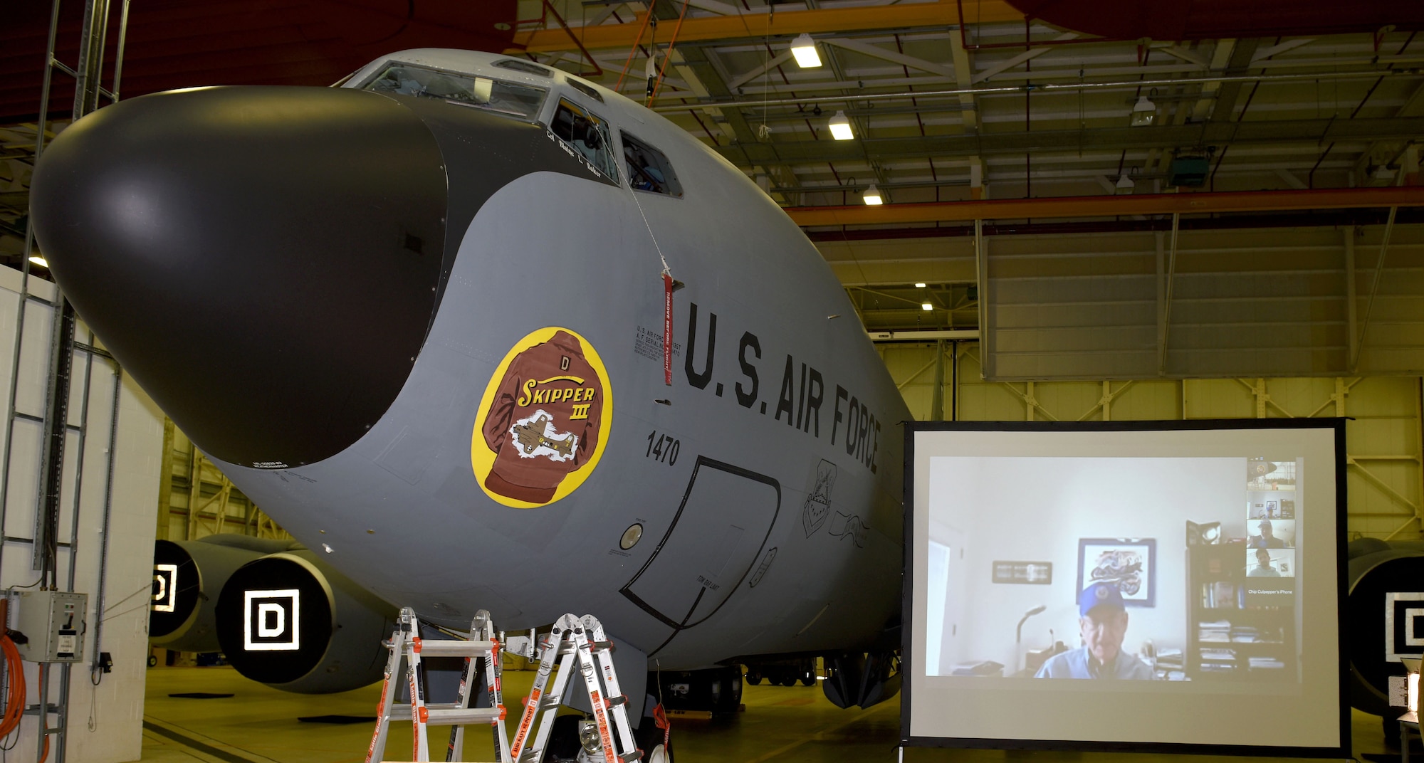 A U.S. Air Force KC-135 Stratotanker aircraft adorns the 100th Air Refueling Wing’s newest heritage nose art, “Skipper III,” as Gary Christopher, on screen, views it virtually during a ceremony at Royal Air Force Mildenhall, May 7, 2021. The nose art, designed by Gary Rogers, 100th ARW Public Affairs graphic artist, is dedicated to Christopher’s father, retired Master Sgt. Dewey Christopher, former 351st Bomb Squadron maintainer and crew chief of the 100th Bombardment Group and World War II. Dewey passed away in 2019. The jet was also “adopted” by the 100th Mission Support Group as part of RAF Mildenhall’s “Adopt-a-Jet” program. (U.S. Air Force photo by Karen Abeyasekere)