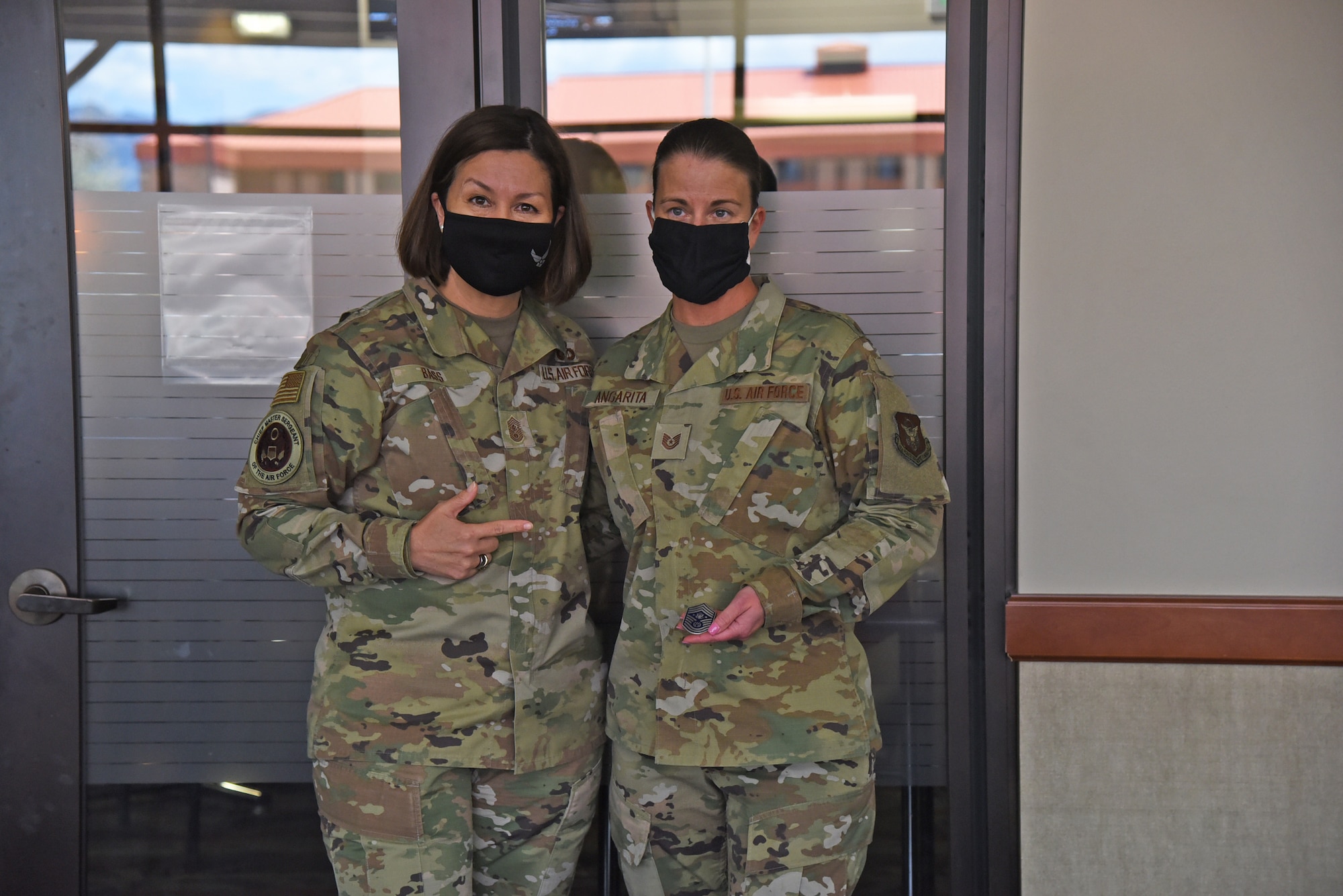 Chief Master Sergeant of the Air Force JoAnne S. Bass coins U.S. Air Force Reserve Tech. Sgt. Donna Angarita, 302nd Logistics Readiness Squadron, during her lunch with junior noncommissioned officers at Peterson Air Force Base, Colorado, May 5, 2021.
