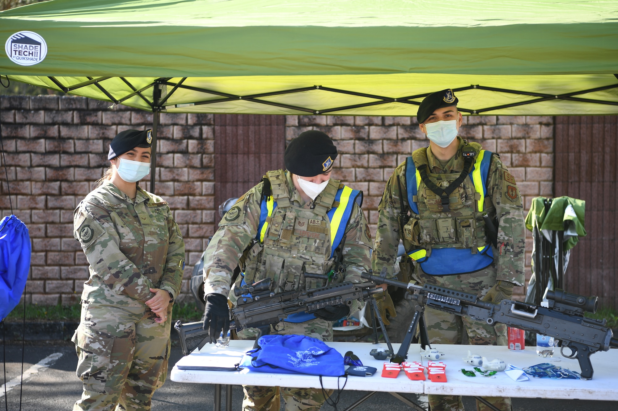 Airmen stand at table