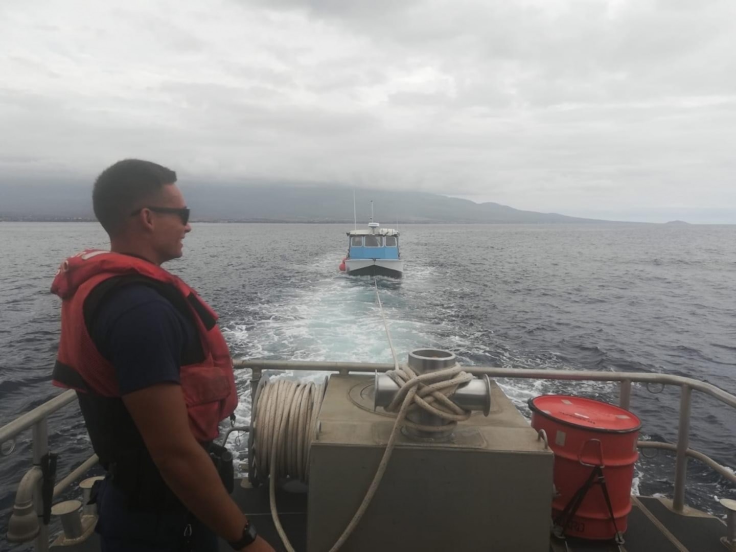 Coast Guard Enlisted Person of the Year, Seaman Theodore Kirkbride, aids in the towing of a vessel in Maui. Kirkbride has assisted in over 15 search and rescue cases, saving over 22 lives. (U.S. Coast Guard courtesy asset)