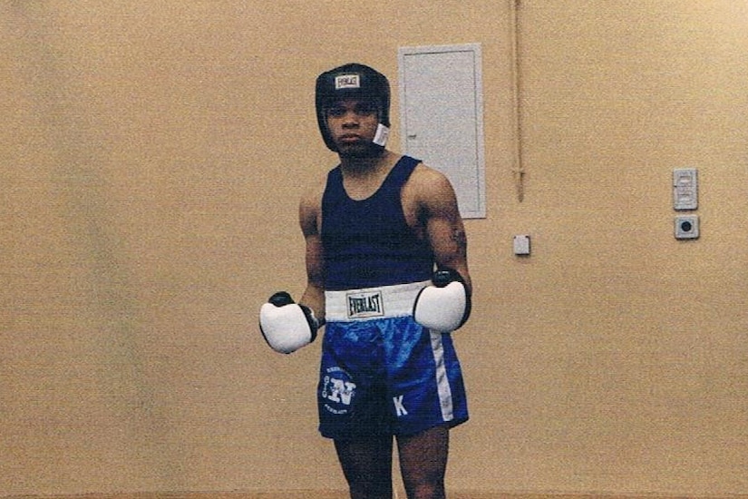 A boxer poses for a photo.