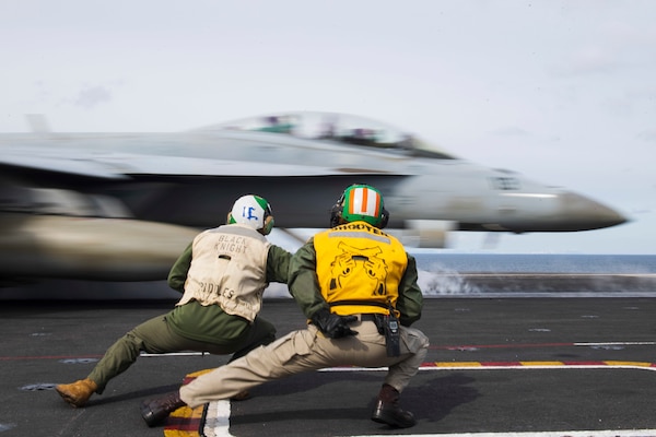 Sailors signal to launch an F/A-18F Super Hornet, assigned to the “Black Knights” of Strike Fighter Squadron (VFA) 154, off of the ship’s flight deck, May 7, 2021.