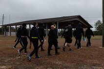 Trainees walk onto a field.