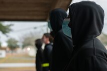 Trainee stands at parade rest.