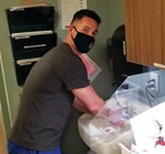 U.S. Army Sgt. John Toomey, a horizontal construction engineer with the 1432nd Engineer Company, Michigan Army National Guard, washes his hands while working as a civilian nurse practitioner for the UP Health System in Marquette, Michigan, April 29, 2021. Toomey recently finished a COVID-19 mobilization with the Michigan National Guard supporting local health care organizations vaccinating Michiganders.