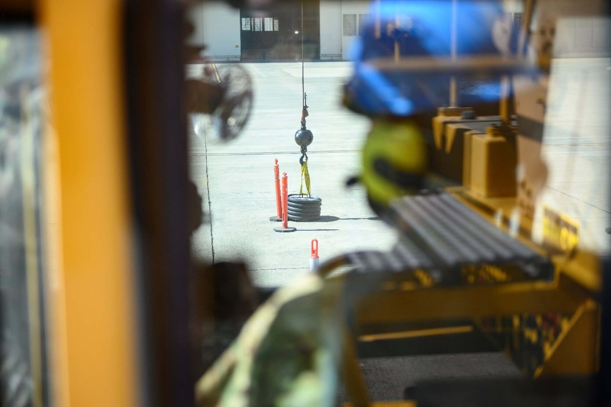 U.S. Air Force Col. Zachery Jiron, 60th Air Mobility Wing vice commander, guides a 50-ton crane through a maneuvering obstacle course during Leadership Rounds May 21, 2021, at the 60th Maintenance Squadron at Travis Air Force Base, California. The obstacle course involved craning a quarter-ton slab of concrete through various checkpoints, testing both mastery of the crane’s controls and fluidity of movement.