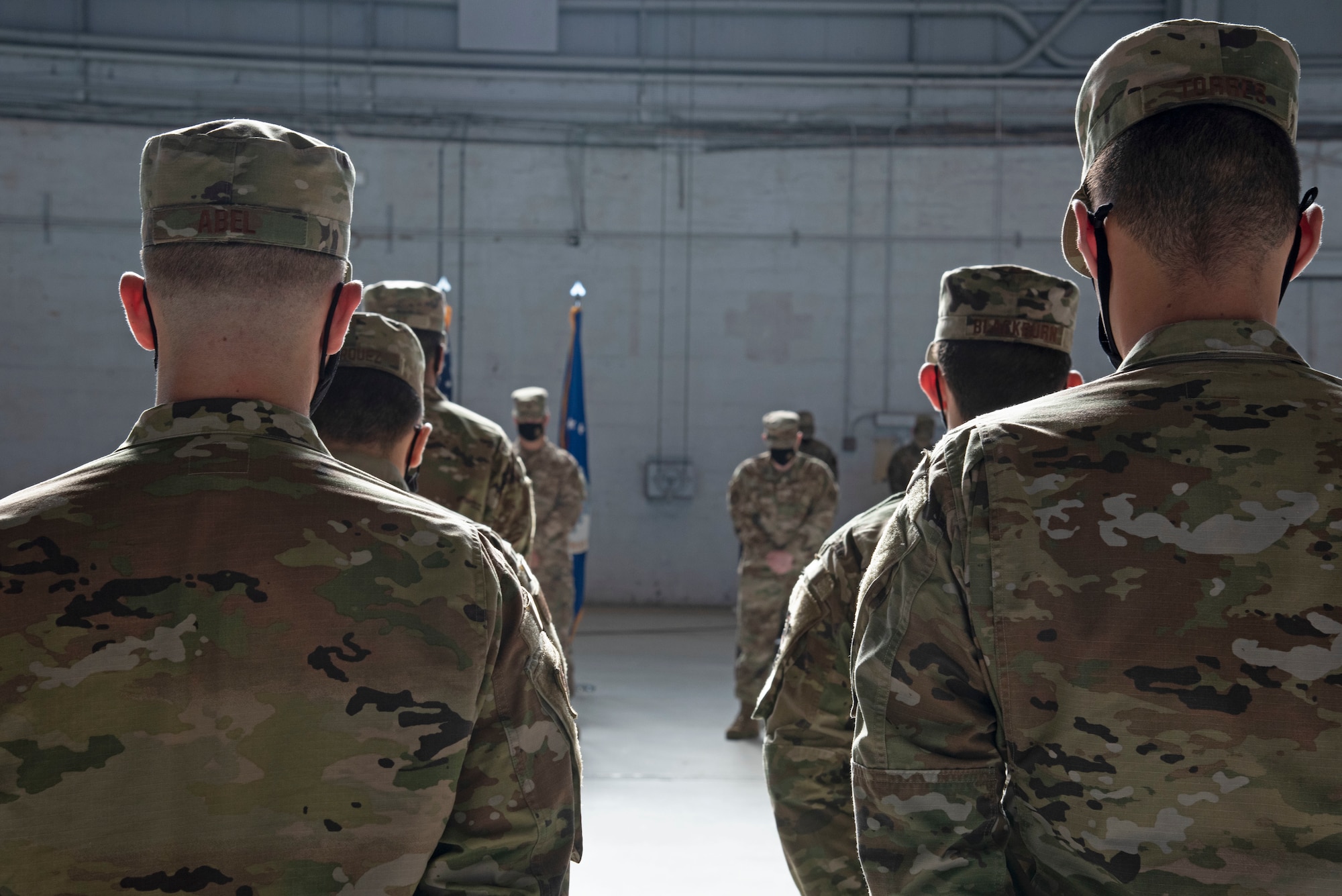 Airmen assigned to the 6th Maintenance Squadron (MXS), stand in formation and bow their heads during a change of command ceremony invocation, at MacDill Air Force Base, Florida, May 10, 2021.