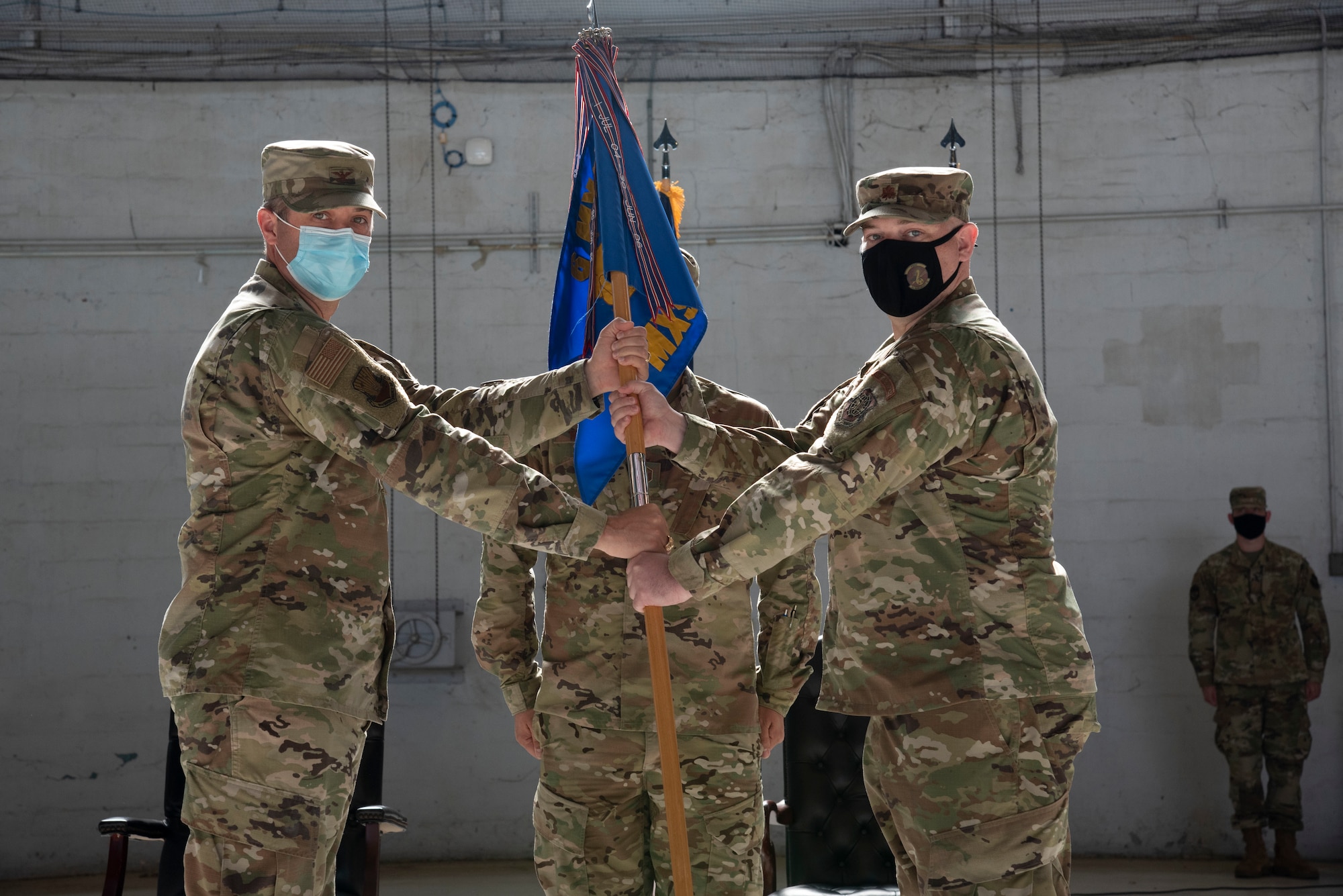 U.S. Air Force Col. Wes Adams, 6th Maintenance Group commander passes the 6th Maintenance Squadron (MXS) guidon to Maj. Aaron W. Darty, incoming 6th MXS commander during a change of command ceremony, May 10, 2021 at MacDill Air Force Base, Florida.