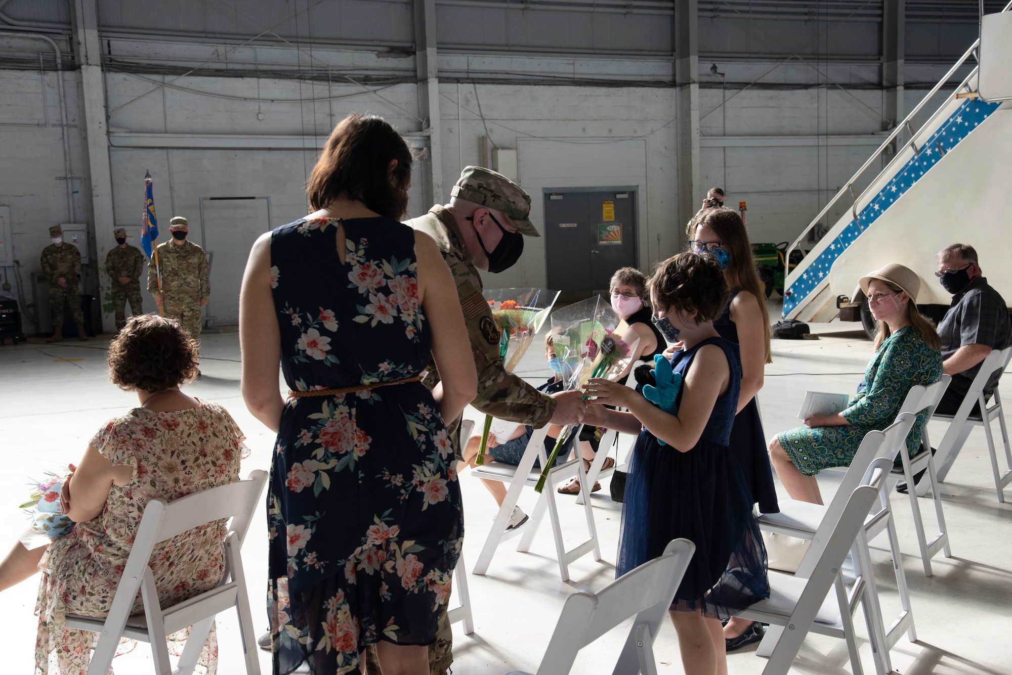 U.S. Air Force Maj. Aaron W. Darty, in-coming 6th Maintenance Squadron commander, presents flowers to his wife Gina and daughters Temple and Grace, during a change of command ceremony, May 10, 2021 at MacDill Air Force Base, Florida.