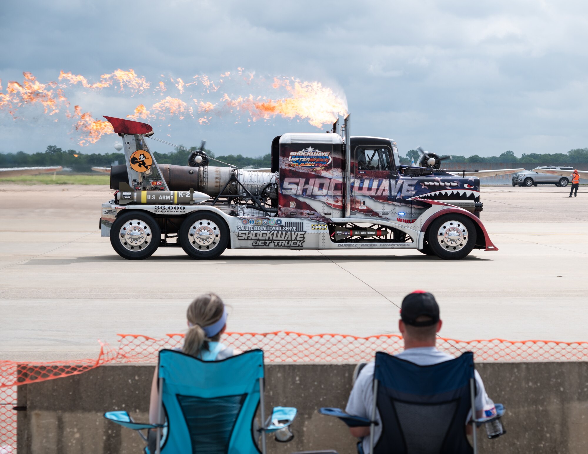 Spectators watch as the Shockwave Jet Truck performs a demonstration at the 2021 Defenders of Liberty Air & Space Show at Barksdale Air Force Base, Louisiana, May 9, 2021. The Barksdale Air Force Base Air & Space Show allows Shreveport-Bossier City to showcase the home of the B-52H Stratofortress, grant access to tour the military installation, view military and aerobatic performers, and support the recruiting arm of our armed forces. (U.S. Air Force photo by Airman 1st Class William Pugh)