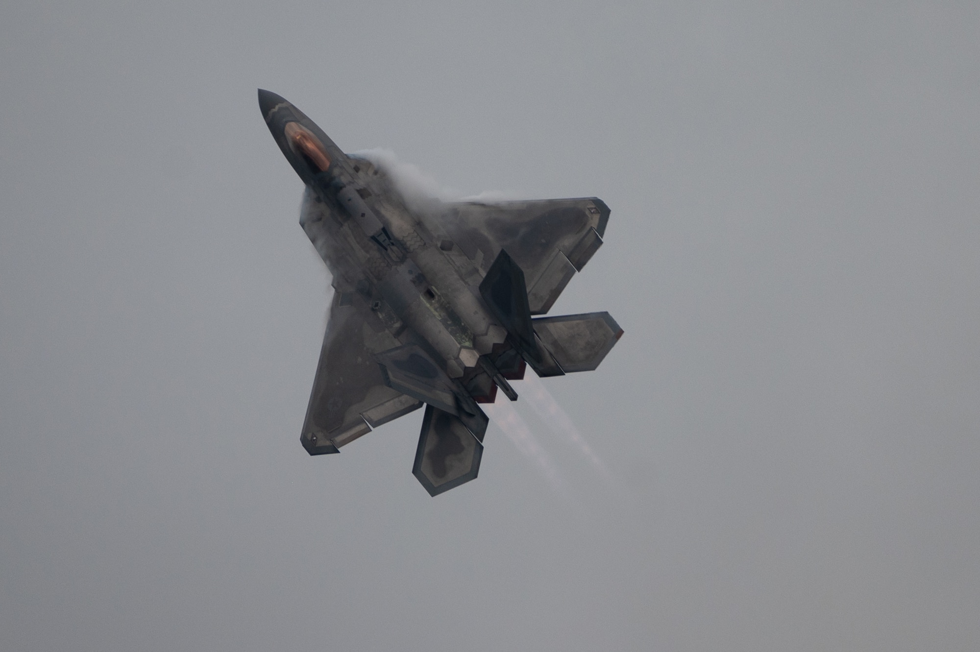 U.S. Air Force F-22A Raptor flies through clouds during the 2021 Defenders of Liberty Air & Space Show at Barksdale Air Force Base, Louisiana, May 9, 2021. The F-22A, a fifth-generation fighter incorporating fourth-generation stealth aircraft, has the ability to fly at supersonic speed without afterburners. (U.S. Air Force photo by Airman 1st Class Jonathan E. Ramos)