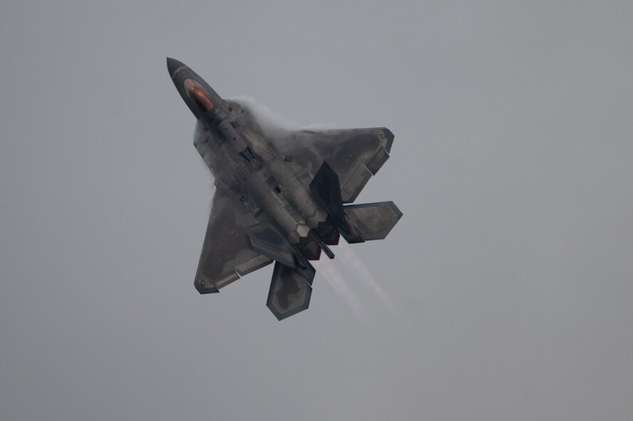 U.S. Air Force F-22A Raptor flies through clouds during the 2021 Defenders of Liberty Air & Space Show at Barksdale Air Force Base, Louisiana, May 9, 2021. The F-22A, a fifth-generation fighter incorporating fourth-generation stealth aircraft, has the ability to fly at supersonic speed without afterburners. (U.S. Air Force photo by Airman 1st Class Jonathan E. Ramos)