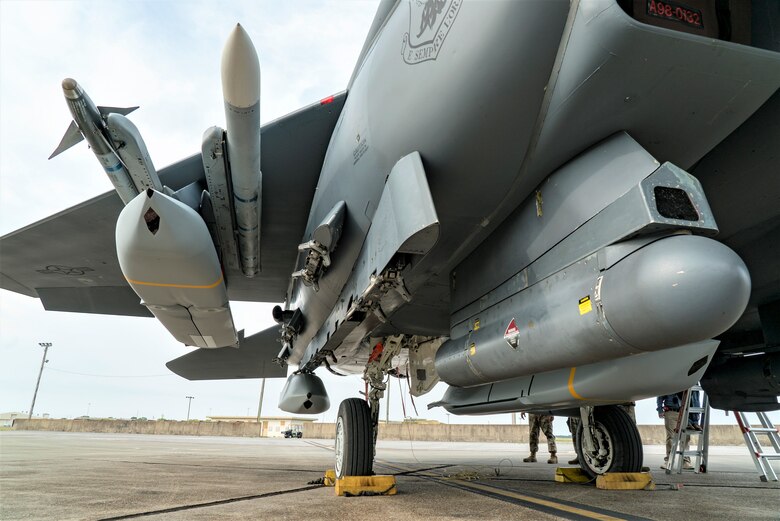 An F-15E Strike Eagle sits on the ramp with five JASSMs loaded